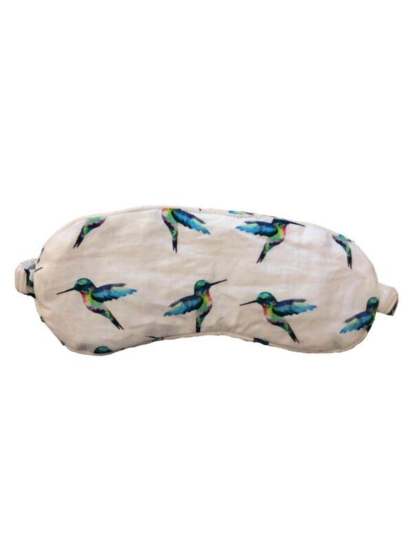 Flat shot of cotton eye mask with hand-painted multi-coloured hummingbird pattern, birds in flight in varying angles