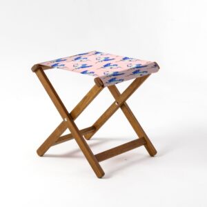 Angled shot of foldable stool with cotton, pale pink base, blue feathered Heron pattern