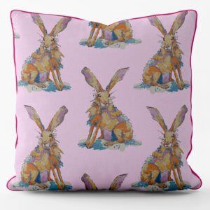 Flat shot of cotton cushion, pale pink base with repeating watercolour hare pattern, pink edge piping