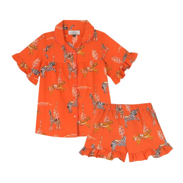 Flat shot of kids cotton, shirt and shorts with frill hems pjs, bright orange base with circus animal pattern with carousel detailing