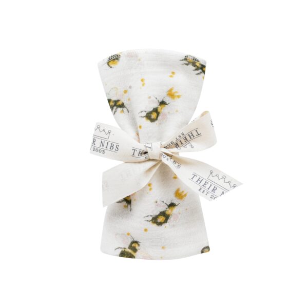 flat shot of rolled and ribbon tied cotton facecloth, white base with watercolour bumble bee pattern with crown detailing