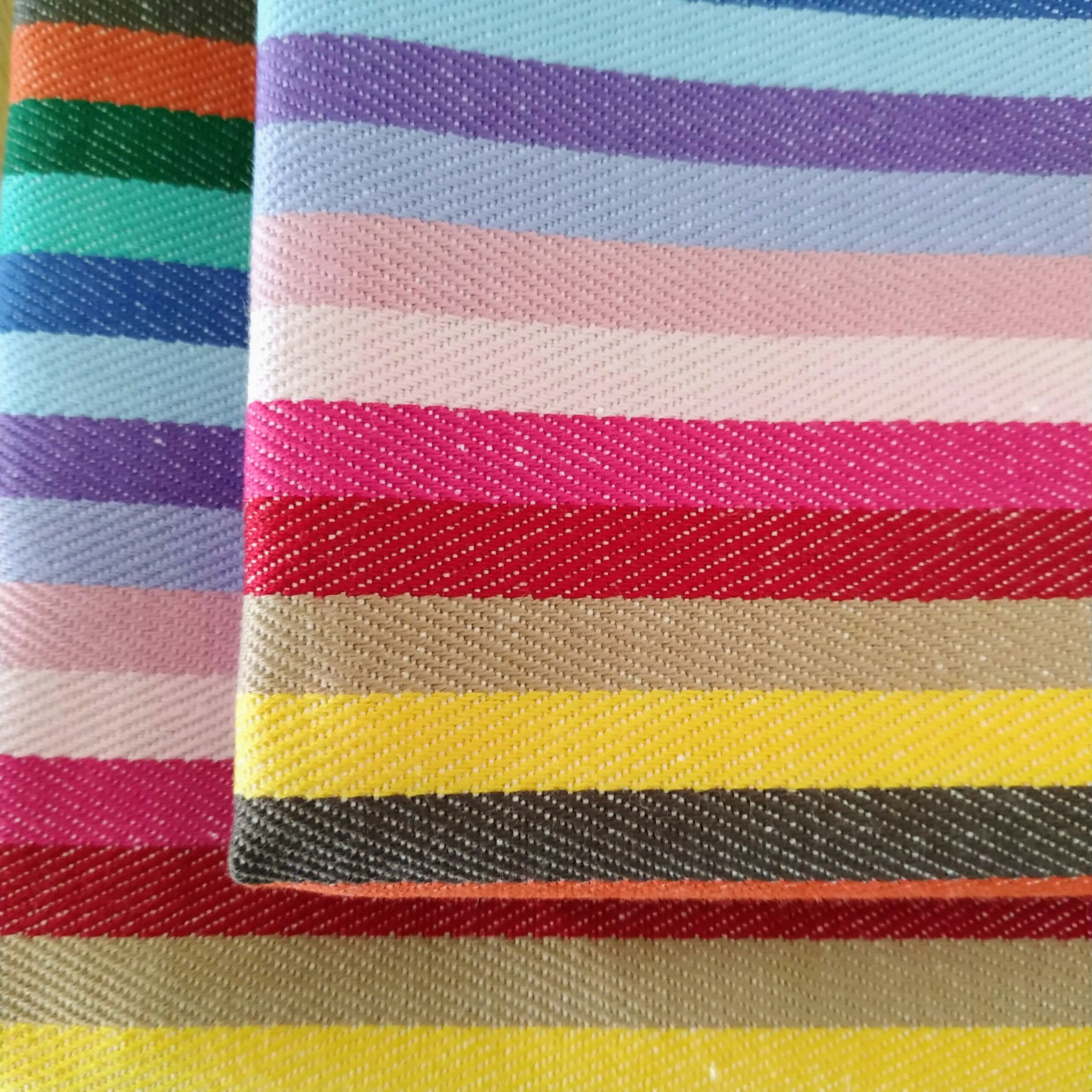 close up of 2 rainbow napkins folded on top of each other